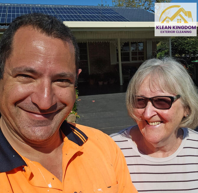Happy customer after a concrete roof restoration in Hebersham, Sydney — coated with Dulux AcraTex by Klean Kingdom Klean Kingdom owner with satisfied customer after concrete roof restoration in Hebersham, Sydney using Dulux AcraTex
