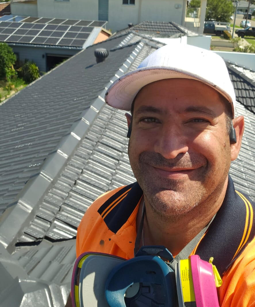 Job complete — full terracotta roof restoration in Monument at Kogarah Bay. A proud finish and an even happier customer. Klean Kingdom owner on a freshly restored terracotta roof coated in Monument colour, Kogarah Bay, Sydney
